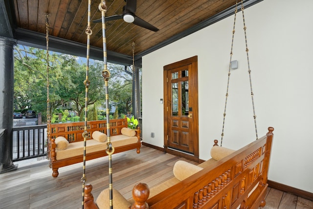 sunroom with wood ceiling and ceiling fan