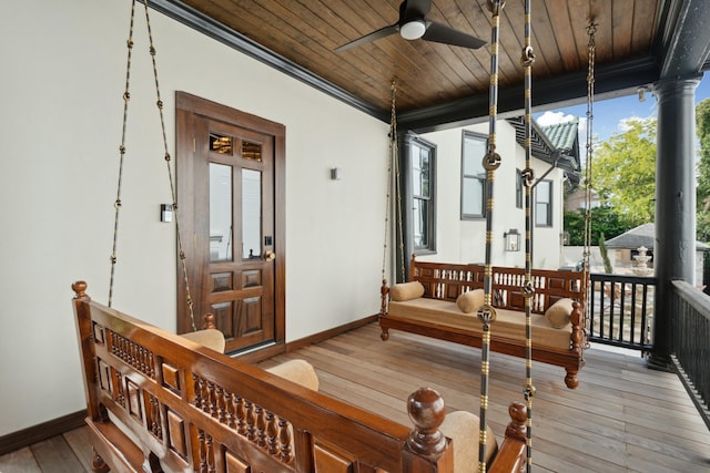 wooden terrace featuring a porch and ceiling fan