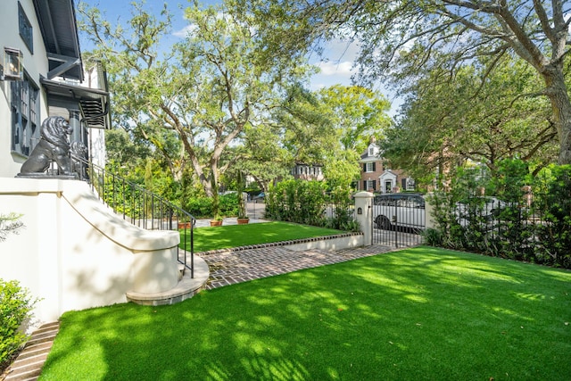 view of yard with fence, stairway, and a patio