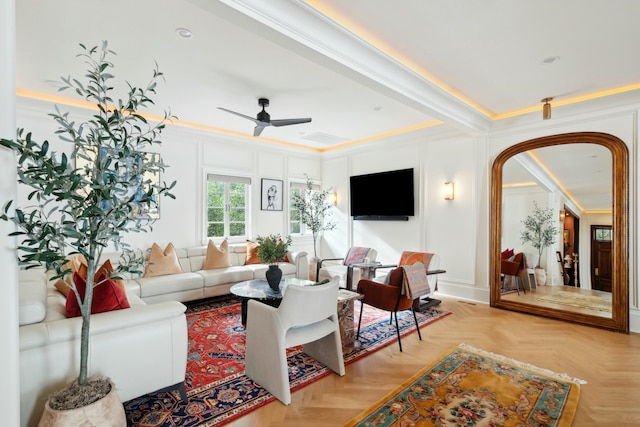 living room featuring ornamental molding, arched walkways, a decorative wall, and a ceiling fan