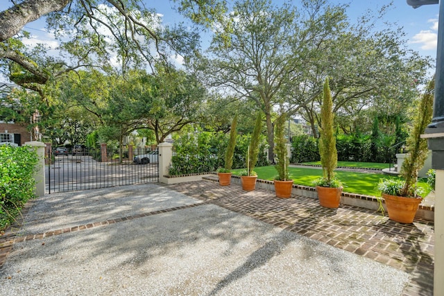 view of patio featuring fence and a gate