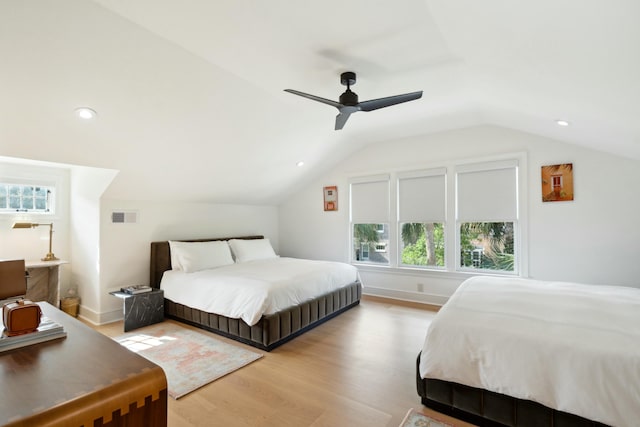 bedroom with vaulted ceiling, a ceiling fan, visible vents, and light wood-style floors