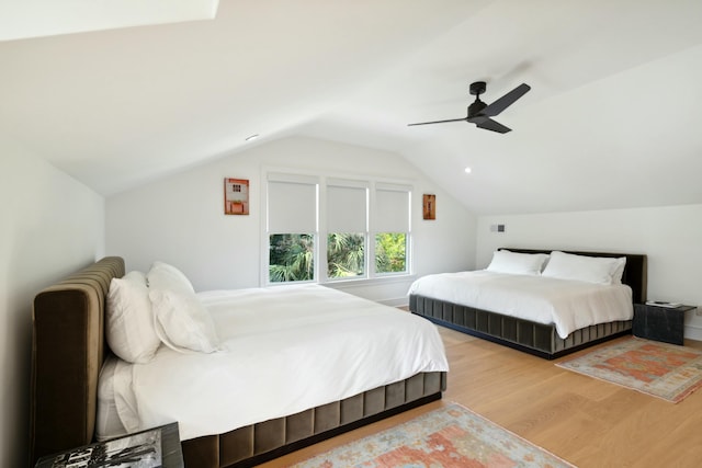 bedroom featuring ceiling fan, vaulted ceiling, and wood finished floors