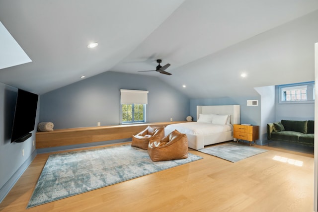 bedroom featuring vaulted ceiling, visible vents, wood finished floors, and a ceiling fan