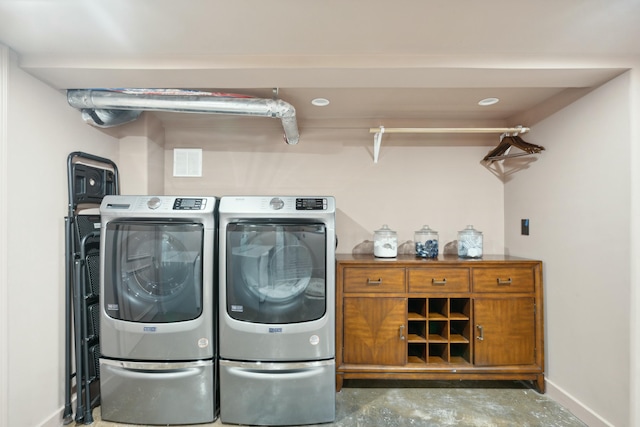 laundry area with laundry area, baseboards, and separate washer and dryer