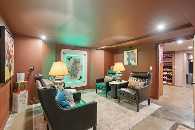 living room featuring baseboards, concrete flooring, and recessed lighting