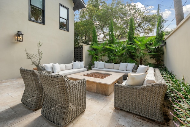 view of patio / terrace featuring fence and an outdoor living space with a fire pit