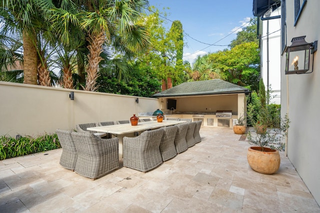 view of patio featuring grilling area, exterior kitchen, and outdoor dining space