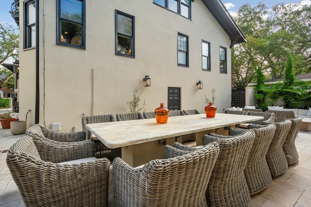 exterior space featuring outdoor dry bar, a patio area, and stucco siding