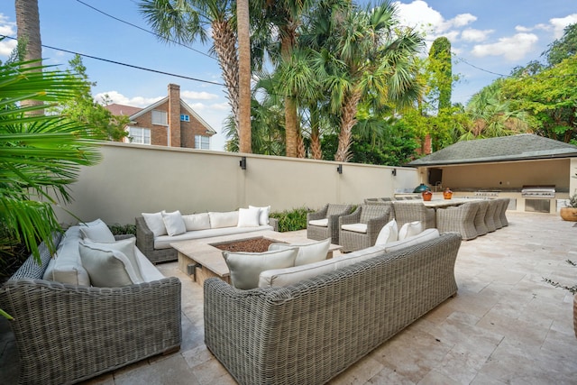 view of patio / terrace featuring an outdoor kitchen, a grill, and an outdoor living space