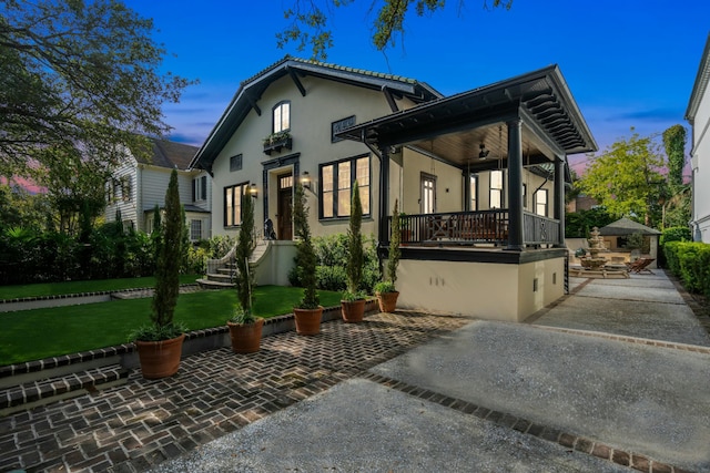 view of front facade with a lawn and stucco siding