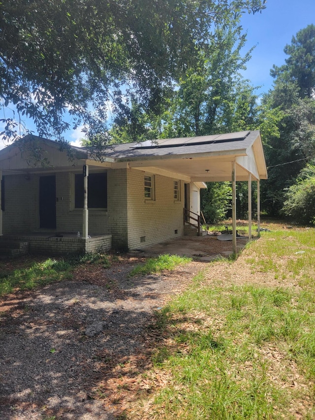 back of property with a carport