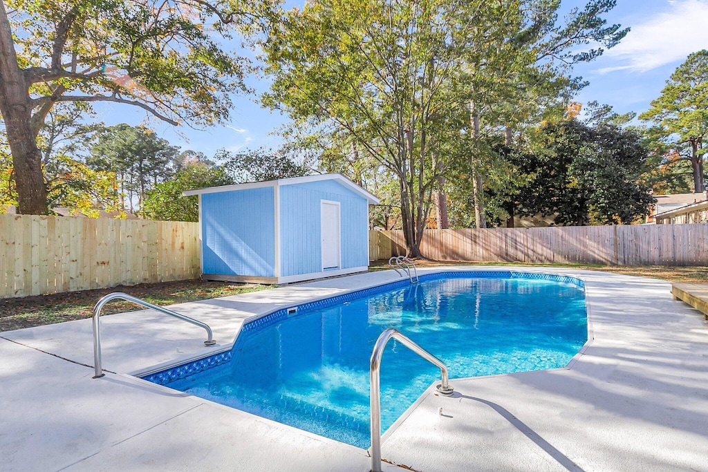 view of pool featuring a storage shed