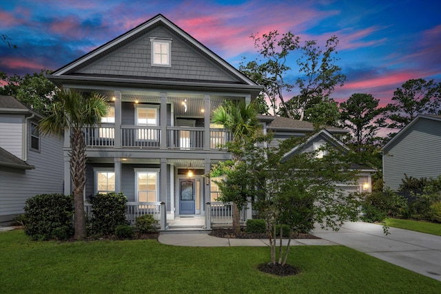 2331 Brinkley Rd, Johns Island, SC 29455 - view of front of property featuring a balcony, covered porch, a yard, and concrete driveway