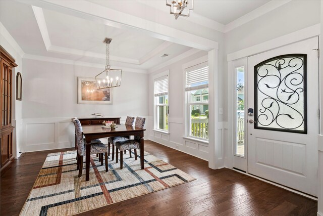 2331 Brinkley Rd, Johns Island, SC 29455 - entryway featuring a chandelier, a decorative wall, dark wood-style flooring, a tray ceiling, and wainscoting