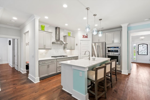 2331 Brinkley Rd, Johns Island, SC 29455 - kitchen with wall chimney exhaust hood, appliances with stainless steel finishes, gray cabinets, crown molding, and a kitchen bar