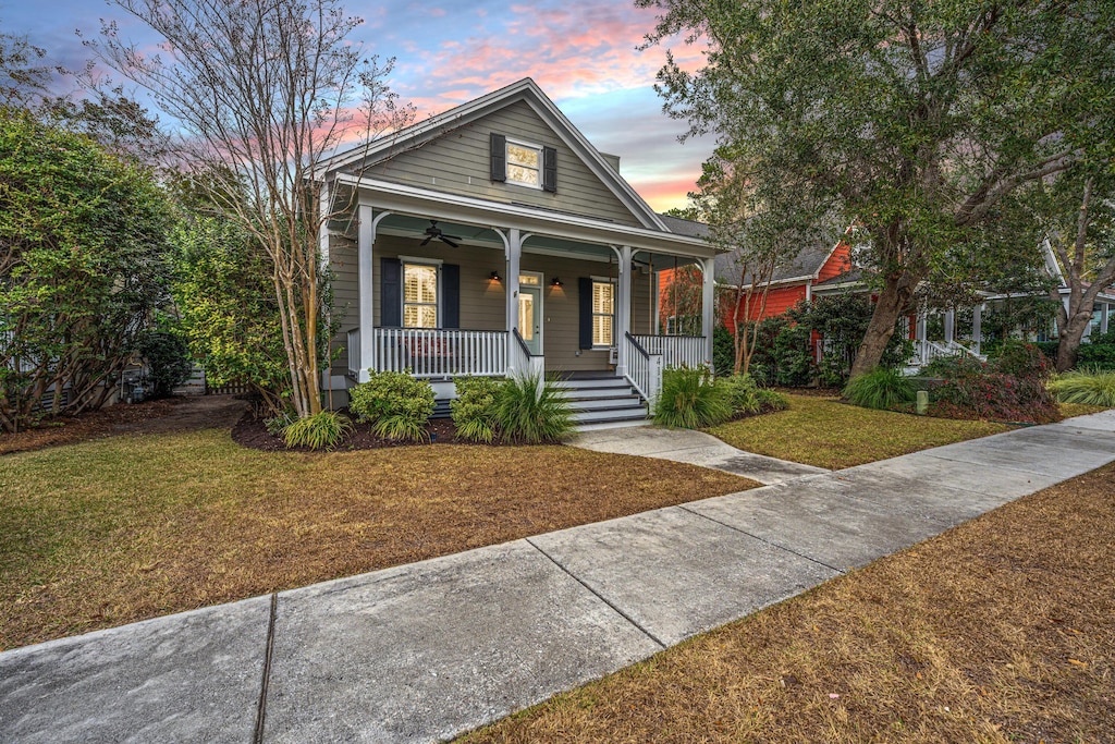 bungalow-style house with a lawn and a porch