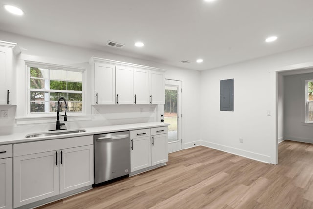 kitchen with sink, stainless steel dishwasher, electric panel, light hardwood / wood-style floors, and white cabinets