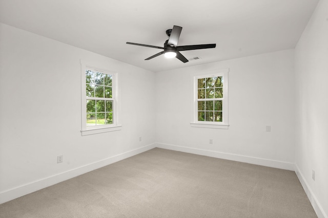 empty room featuring carpet and ceiling fan