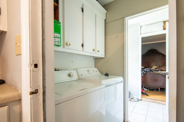 7621 Oldridge Rd, North Charleston, SC 29418 - laundry room with washing machine and clothes dryer, cabinet space, and light tile patterned floors
