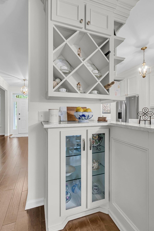 2467 Bergeron Way, Mount Pleasant, SC 29466 - bar with dark wood-style floors, a chandelier, and stainless steel fridge