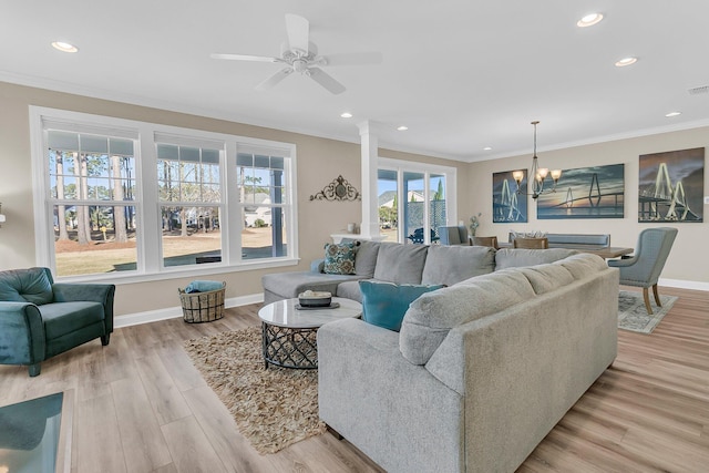living area featuring baseboards, light wood-type flooring, crown molding, and recessed lighting