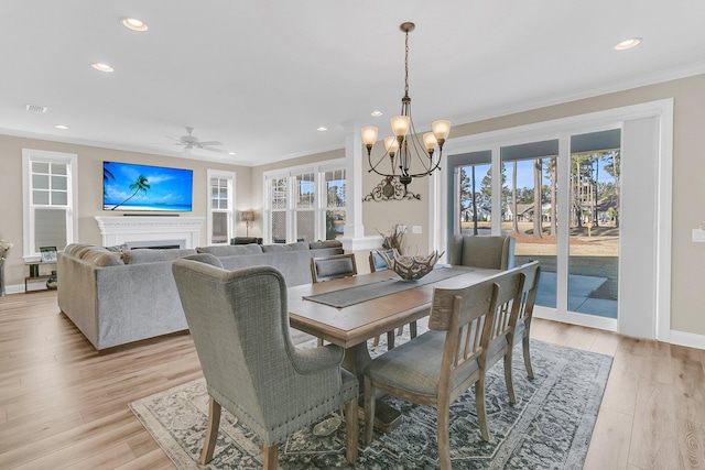 dining room with baseboards, light wood-type flooring, recessed lighting, and ornamental molding