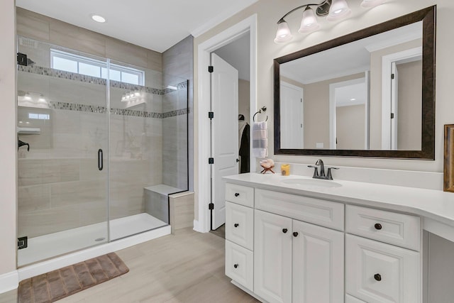 full bath with a stall shower, ornamental molding, and vanity