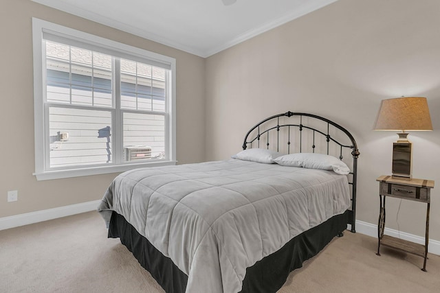 bedroom featuring carpet floors, ornamental molding, and baseboards