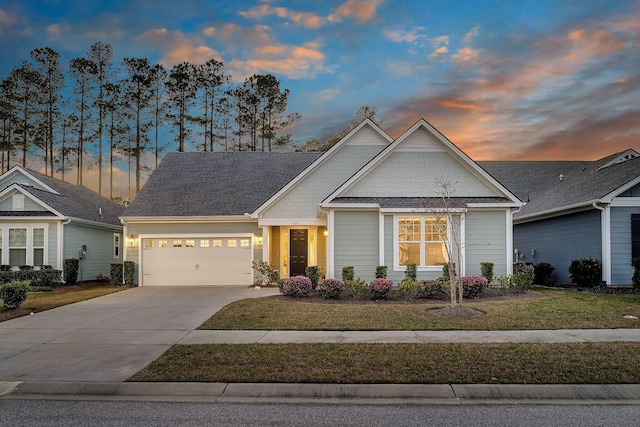 craftsman-style home with a front lawn, a garage, and concrete driveway