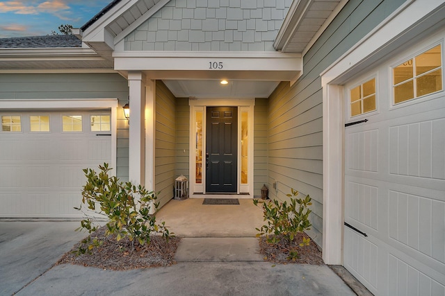 entrance to property featuring an attached garage