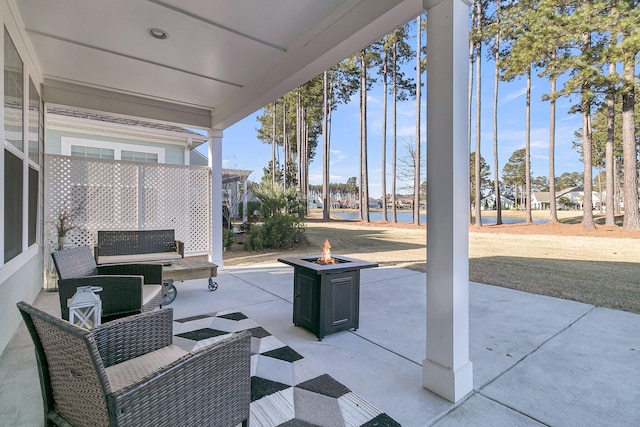 view of patio with an outdoor living space with a fire pit