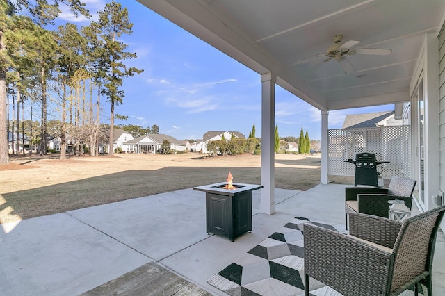 view of patio featuring an outdoor fire pit, area for grilling, and ceiling fan