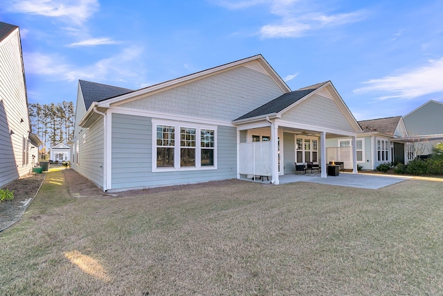 back of property featuring a patio, ceiling fan, and a yard