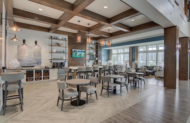 dining area featuring a community bar, parquet floors, coffered ceiling, and beam ceiling