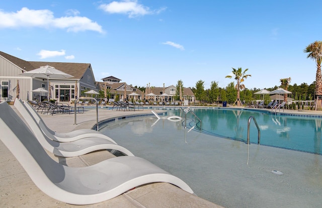 pool with a patio and a residential view
