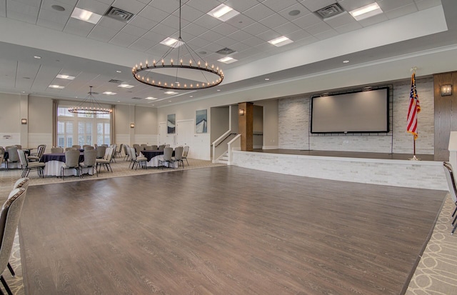 exercise room with a wainscoted wall, wood finished floors, and visible vents