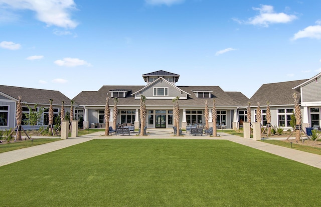 back of property featuring a yard and a patio area