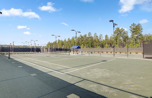 view of tennis court with fence