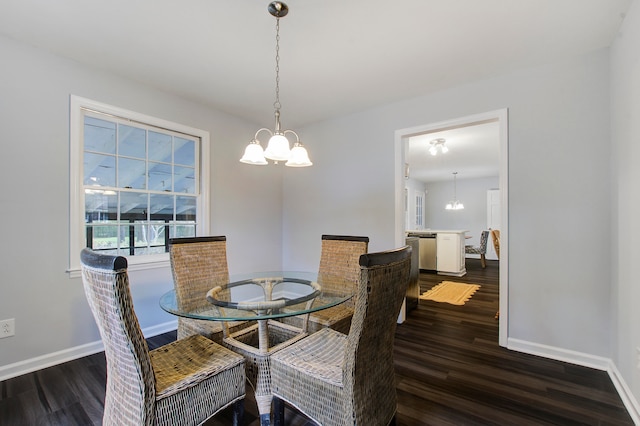 dining area with an inviting chandelier and dark wood-type flooring