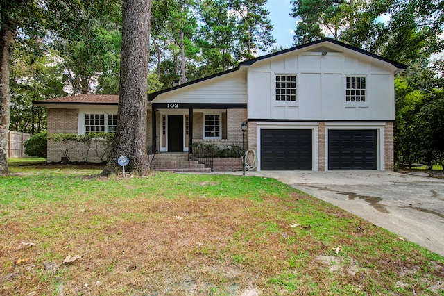 split level home with a front lawn and a garage