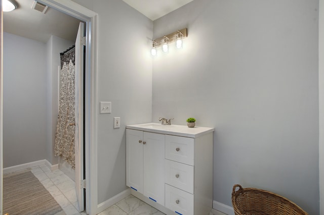 bathroom featuring vanity and curtained shower