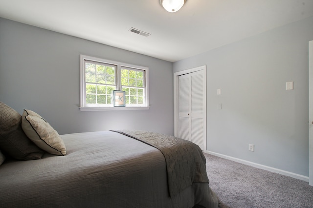 carpeted bedroom with a closet