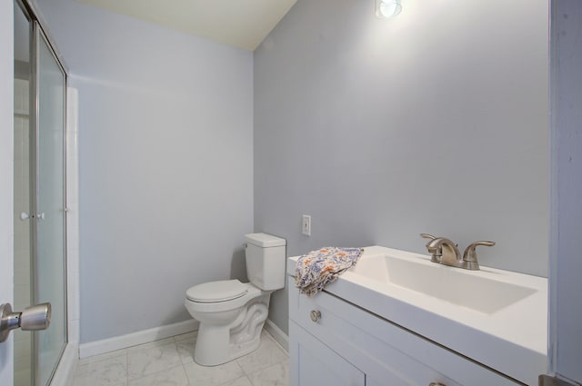 bathroom with an enclosed shower, vanity, and toilet