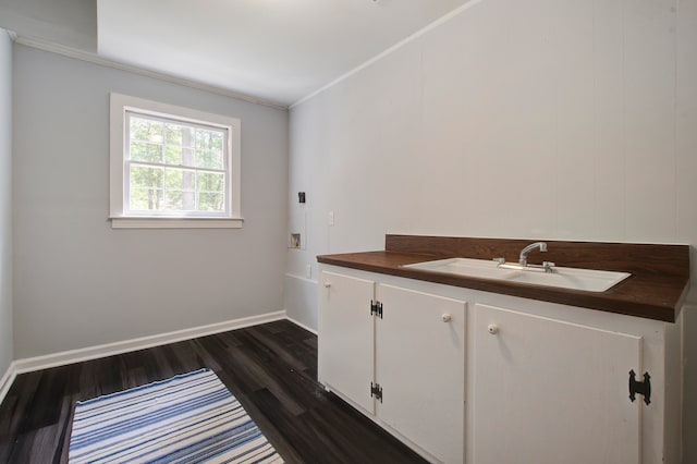 bathroom featuring ornamental molding, hardwood / wood-style flooring, and vanity