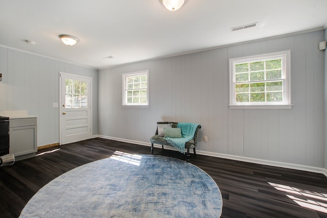 living area featuring wooden walls and dark hardwood / wood-style floors