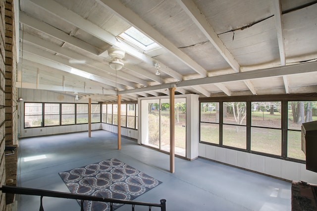 unfurnished sunroom with vaulted ceiling with skylight, ceiling fan, and a wealth of natural light