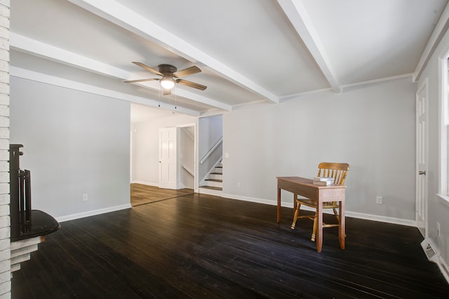 interior space featuring beam ceiling, ceiling fan, a fireplace, and dark wood-type flooring