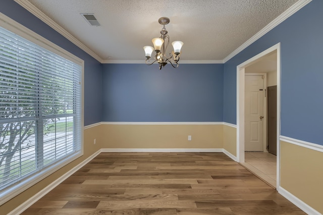 1616 Dotterers Run, Charleston, SC 29414 - unfurnished room featuring plenty of natural light, a chandelier, a textured ceiling, wood finished floors, and crown molding