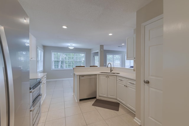 1616 Dotterers Run, Charleston, SC 29414 - kitchen featuring appliances with stainless steel finishes, white cabinetry, a peninsula, light countertops, and recessed lighting
